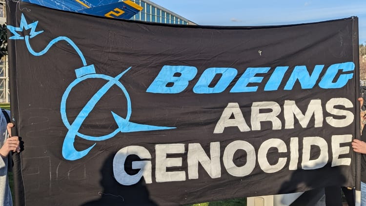 protest sign with the text Boeing arms genocide