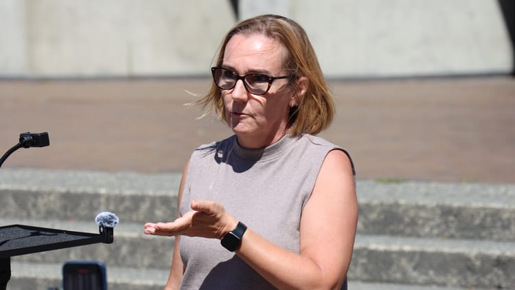 women speaking into microphone